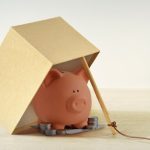 Piggy bank in box trap - Financial scam traps concept